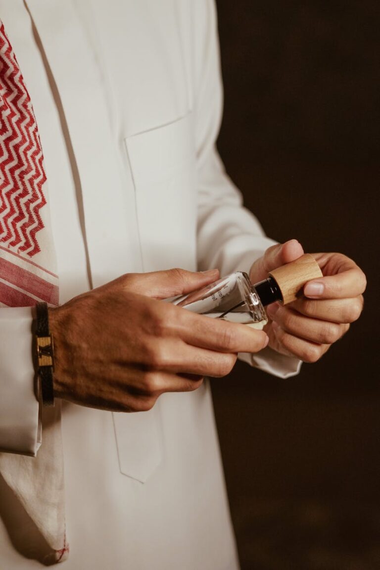 man hands holding perfume